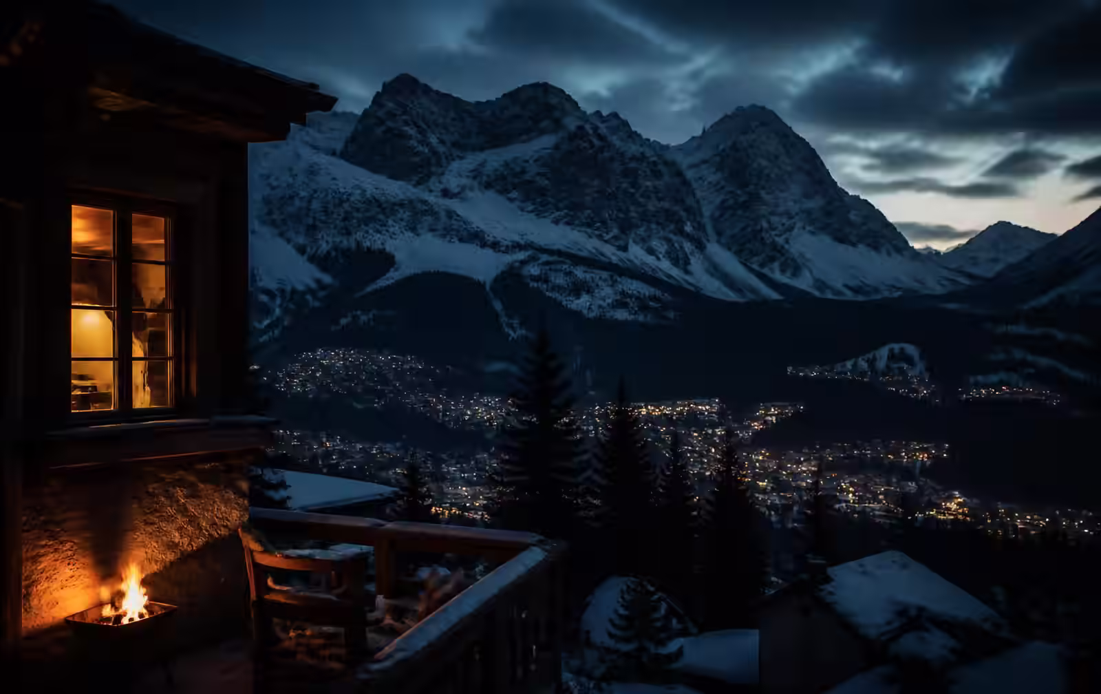 A lit chalet window and fireside terrace above the snow-covered valley of Cortina d’Ampezzo at dusk