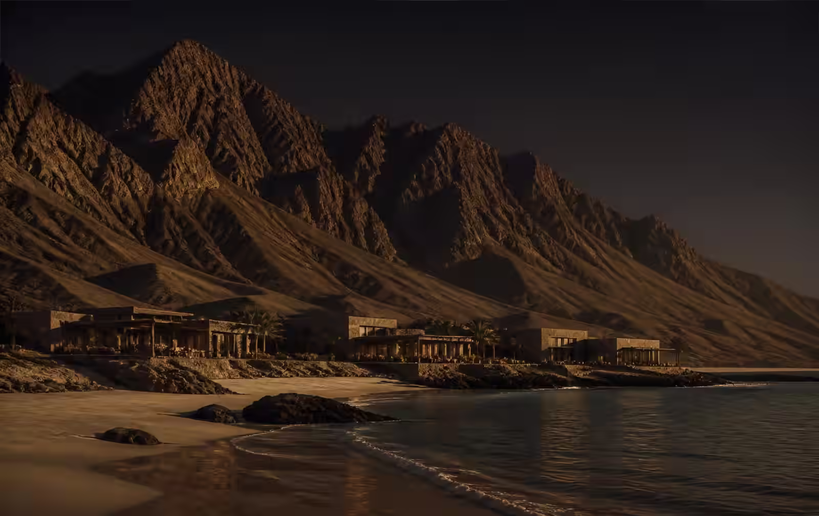 A rugged desert mountain range meeting a quiet coastline at dusk with a low resort silhouette in warm gold light