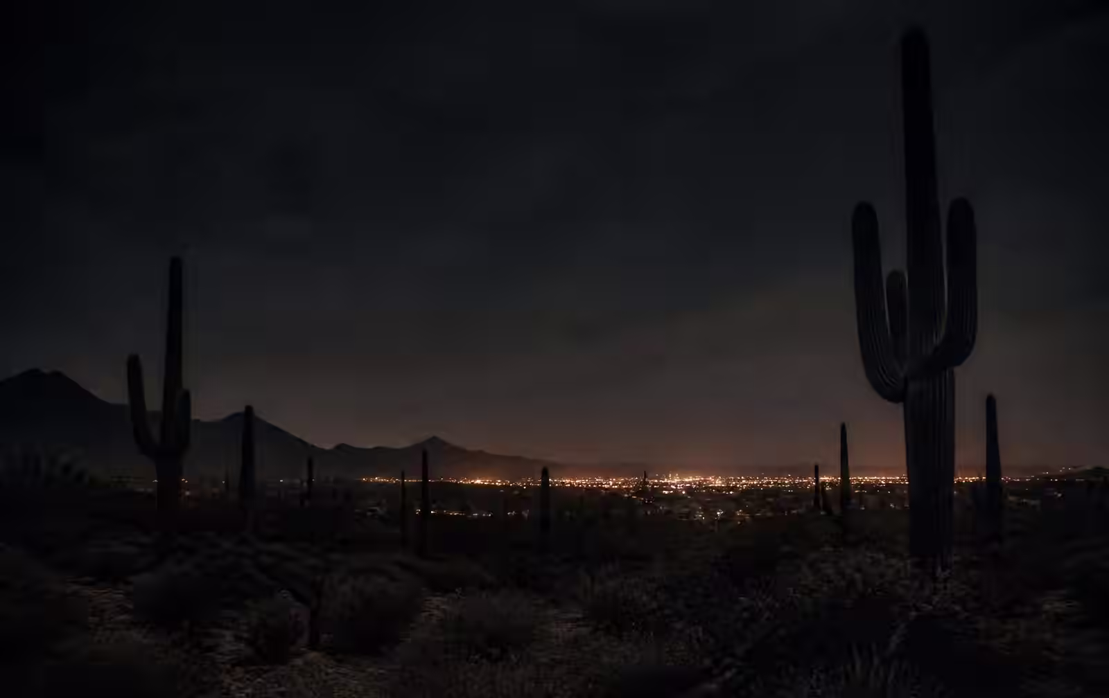 Desert mountains glowing warm orange at sunset above a quiet Arizona valley