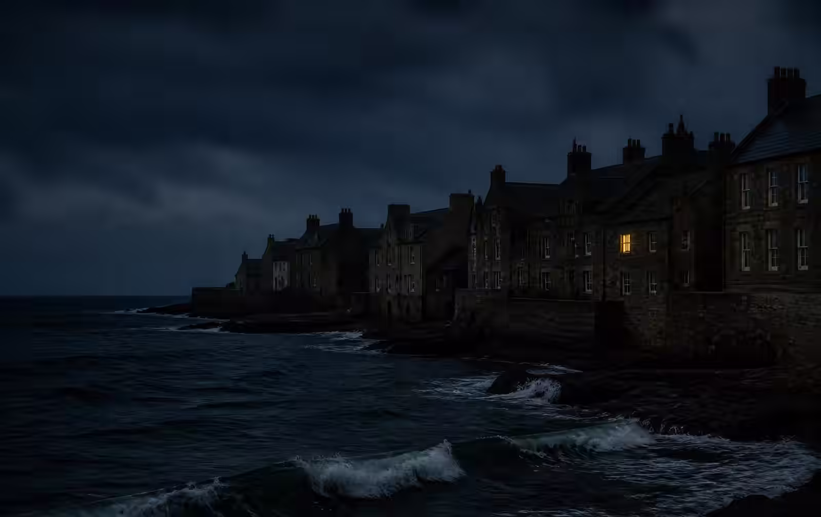 Grey stone Scottish coastal houses at night above dark North Sea waves with one lit window