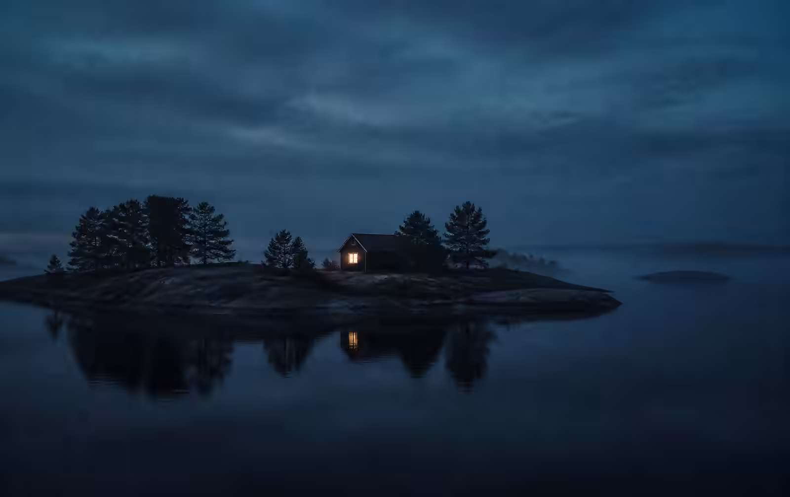 A Baltic archipelago island at blue hour, granite shore and pines silhouetted on still dark water with one small house showing a warm lit window