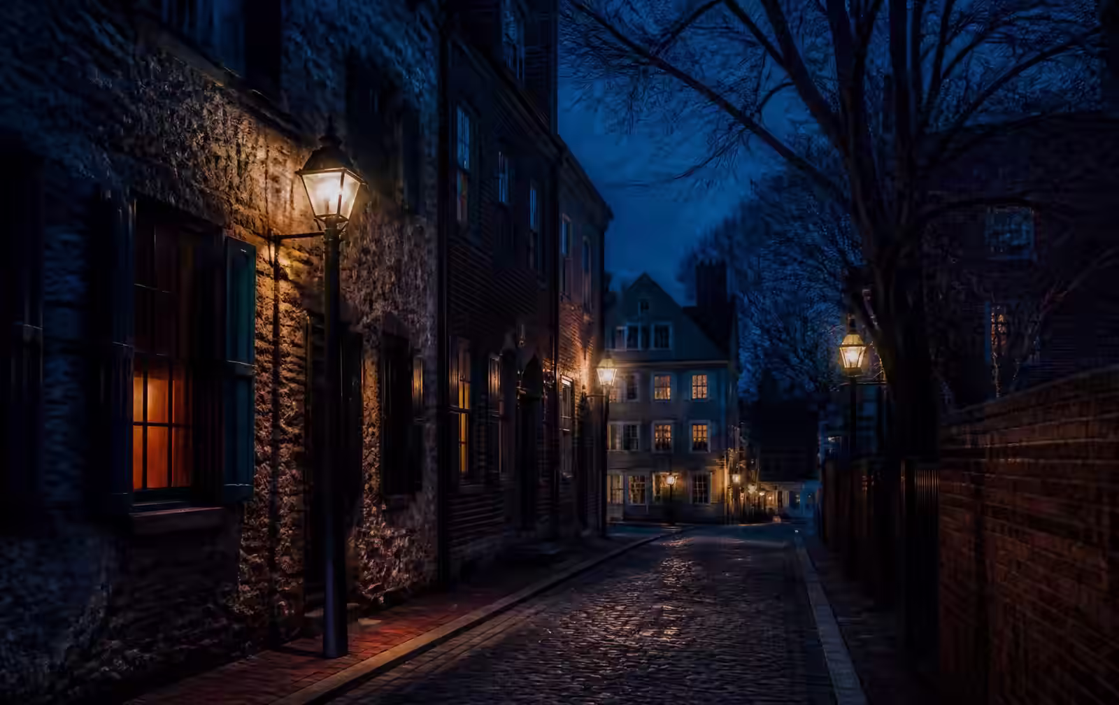 A dim, book-lined Boston room at dusk with lamplight against old brick and a rain-streaked window