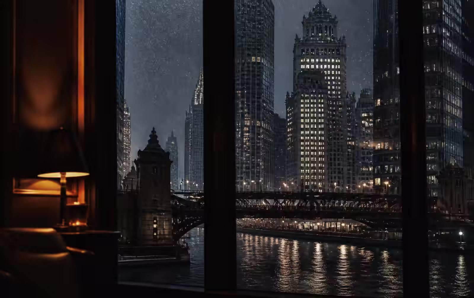 Warmly lit Chicago high-rise apartment window at night overlooking the dark lakefront skyline