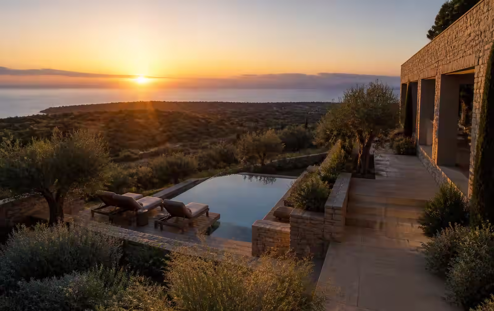 A refined Messinia retreat overlooking olive groves and the Ionian coast at sunset