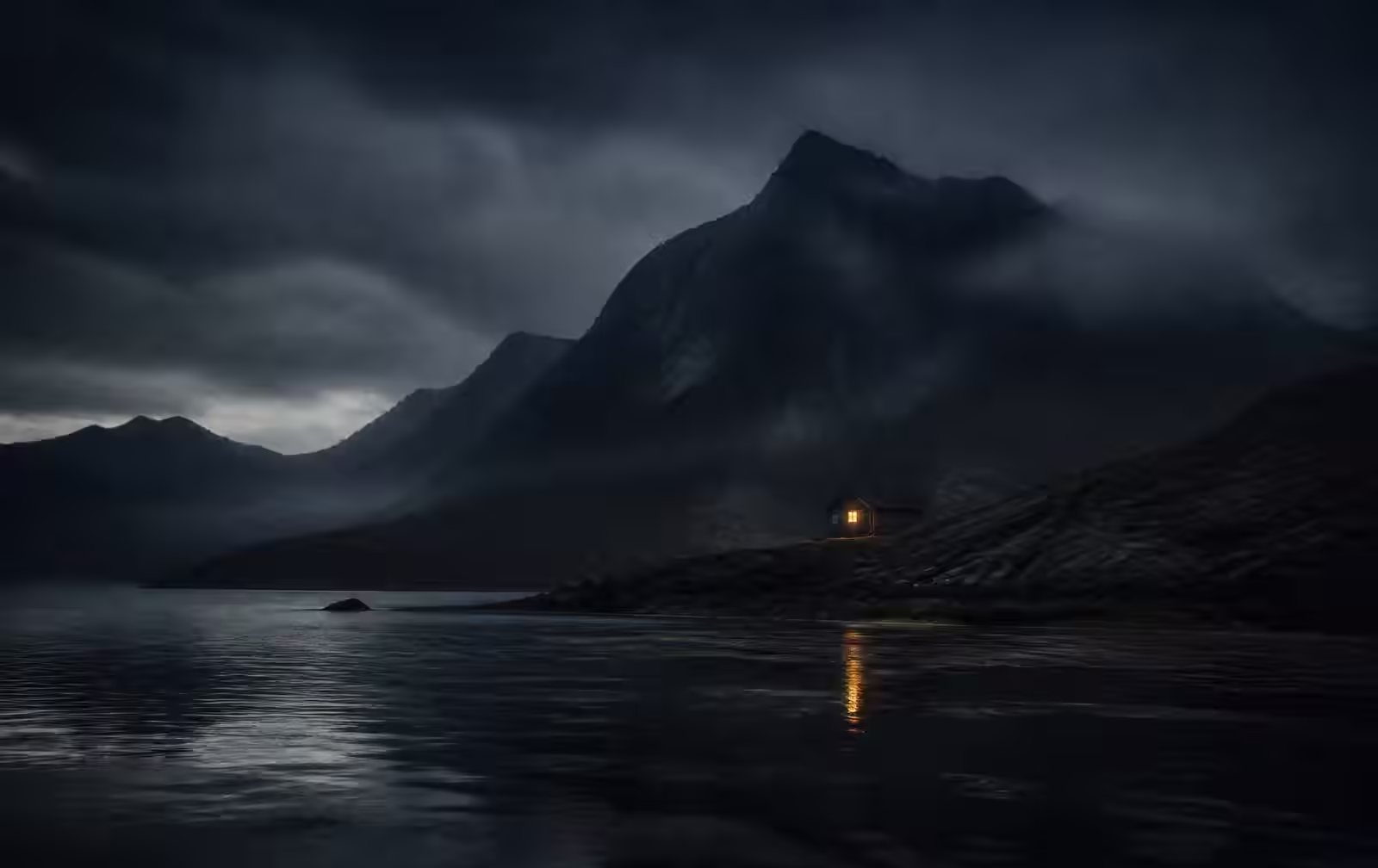 Cold island wilderness at dusk with dark mountains, mist over still water and one warm lit cabin window