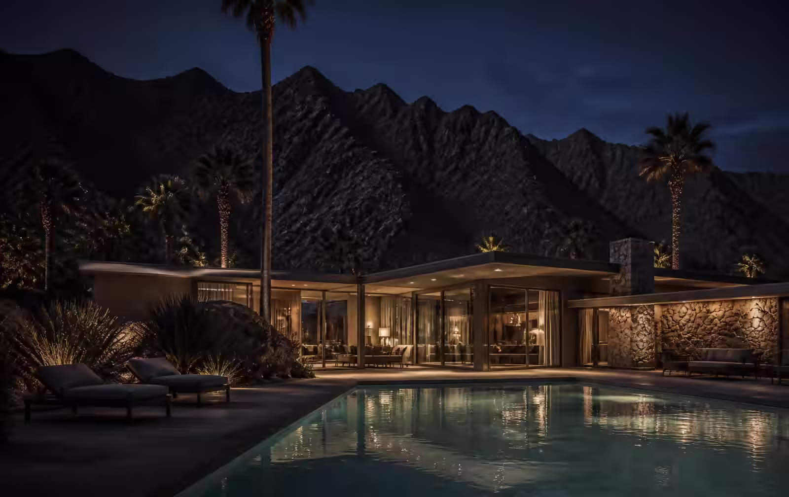 Palm Springs desert resort at dusk with warm light and mountains silhouetted in the background