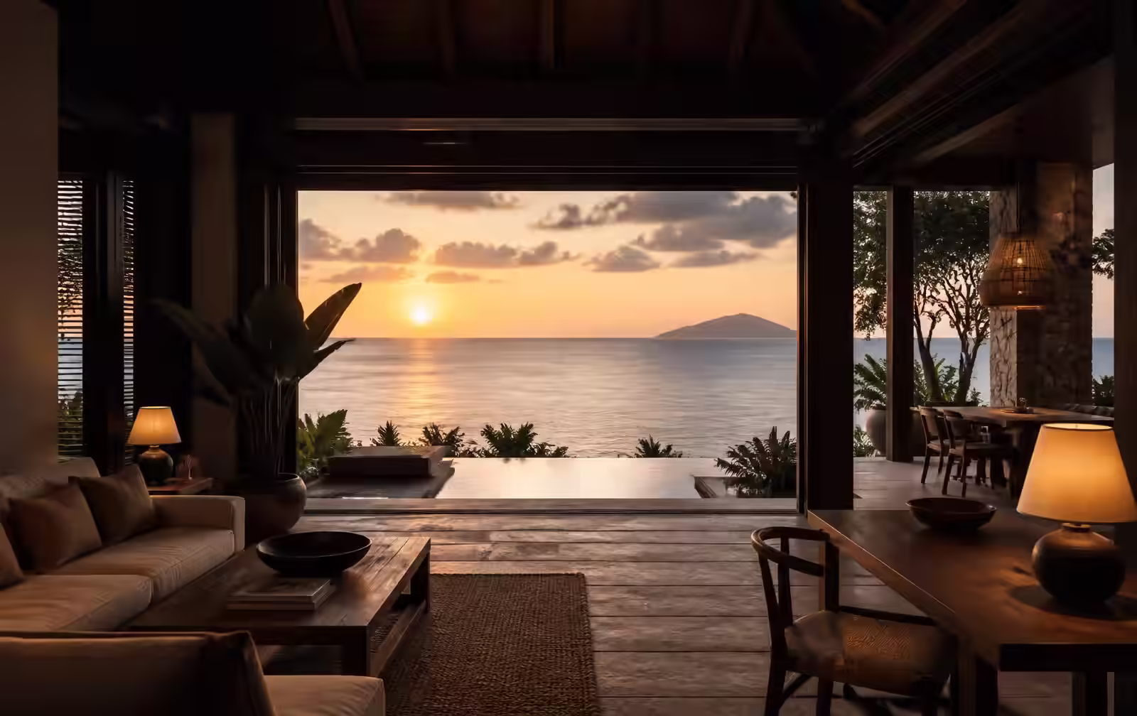 A modern dark-timber island interior open to a warm southern sunset over the ocean