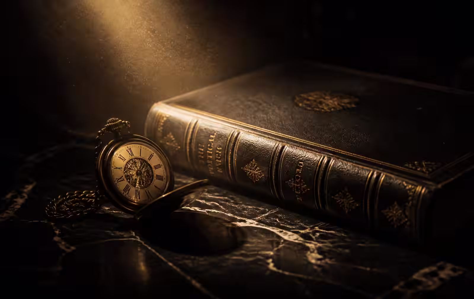 An antique pocket watch resting beside a leather-bound book on dark marble