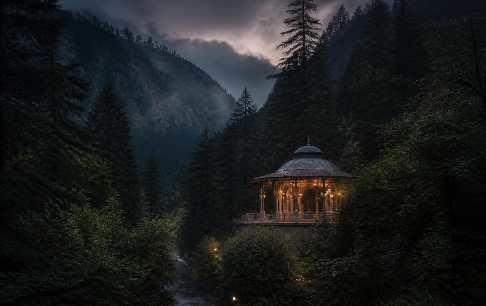 Borjomi gorge at dusk, a lit historic pavilion among tall pines in the forested valley