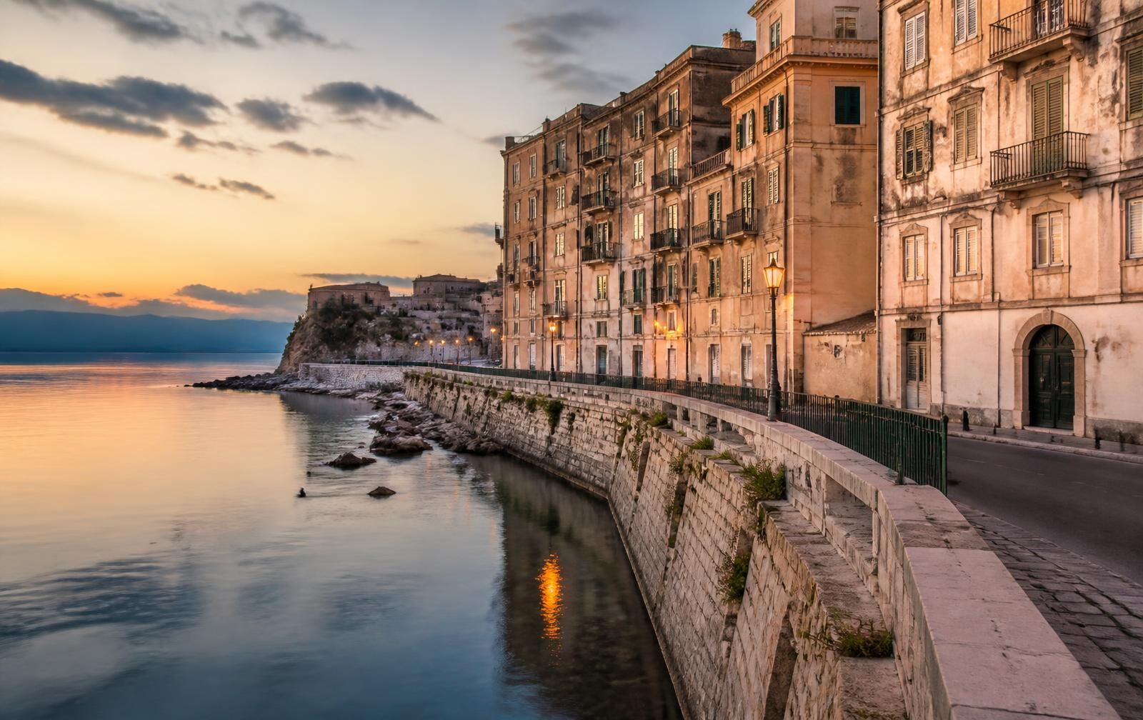 Old-world waterfront architecture in Corfu glowing in the evening light