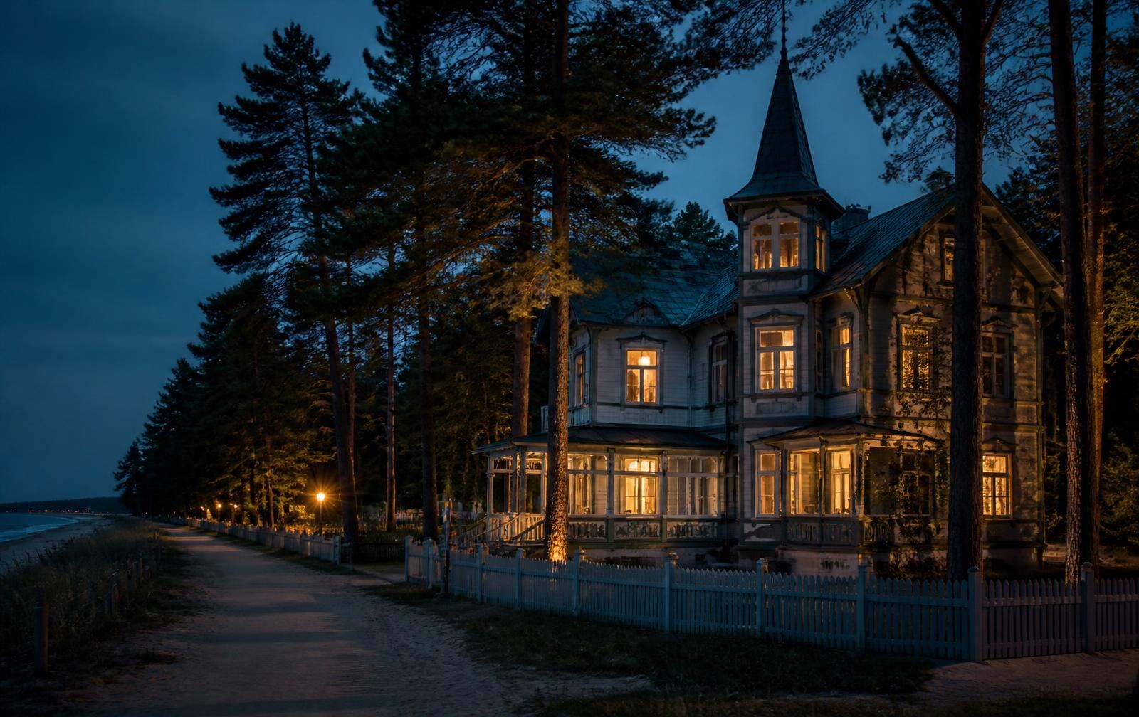 A historic wooden villa in Jūrmala at dusk, warm windows among tall pines beside a quiet sandy path to the sea