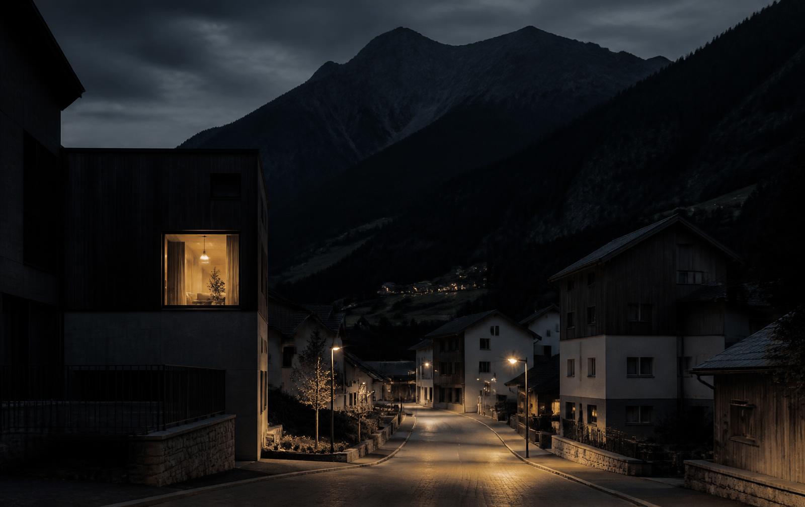 A quiet lamplit street in Schaan at night with one warmly lit window and a dark mountain ridge behind