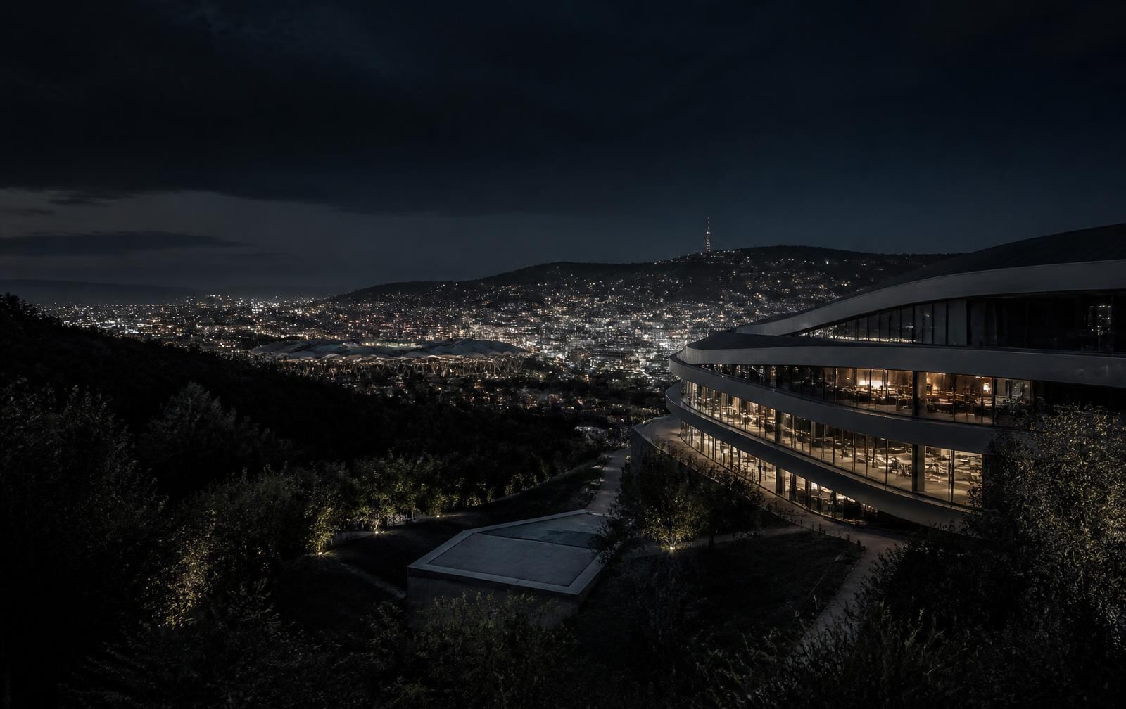 Stuttgart at night seen from the vineyard hills, with city lights in the valley below and a dark understated interior in the foreground
