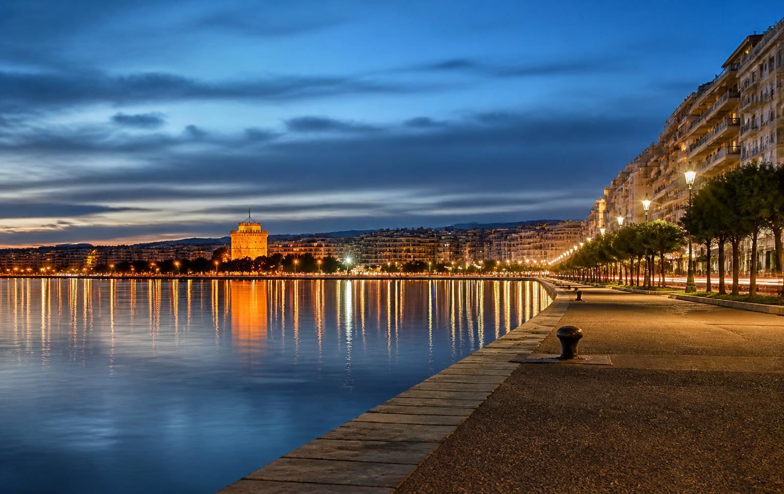 Thessaloniki waterfront and White Tower illuminated at blue hour