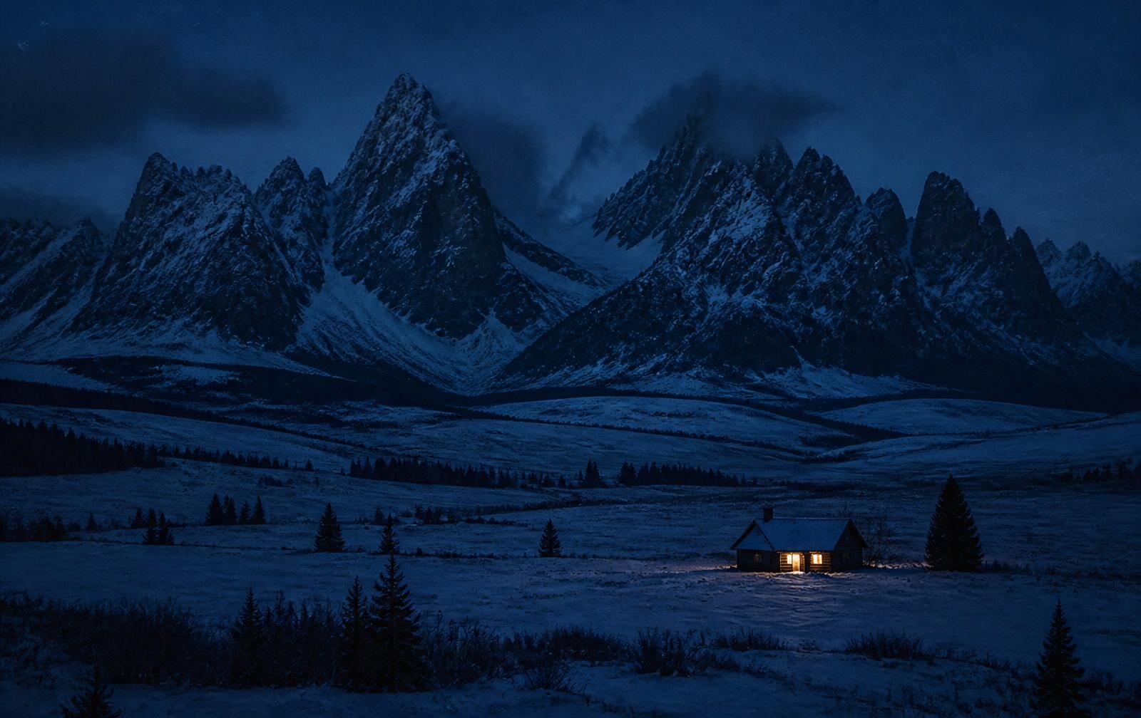 Vast snowy Wyoming valley beneath dark jagged peaks with a single lit cabin at night