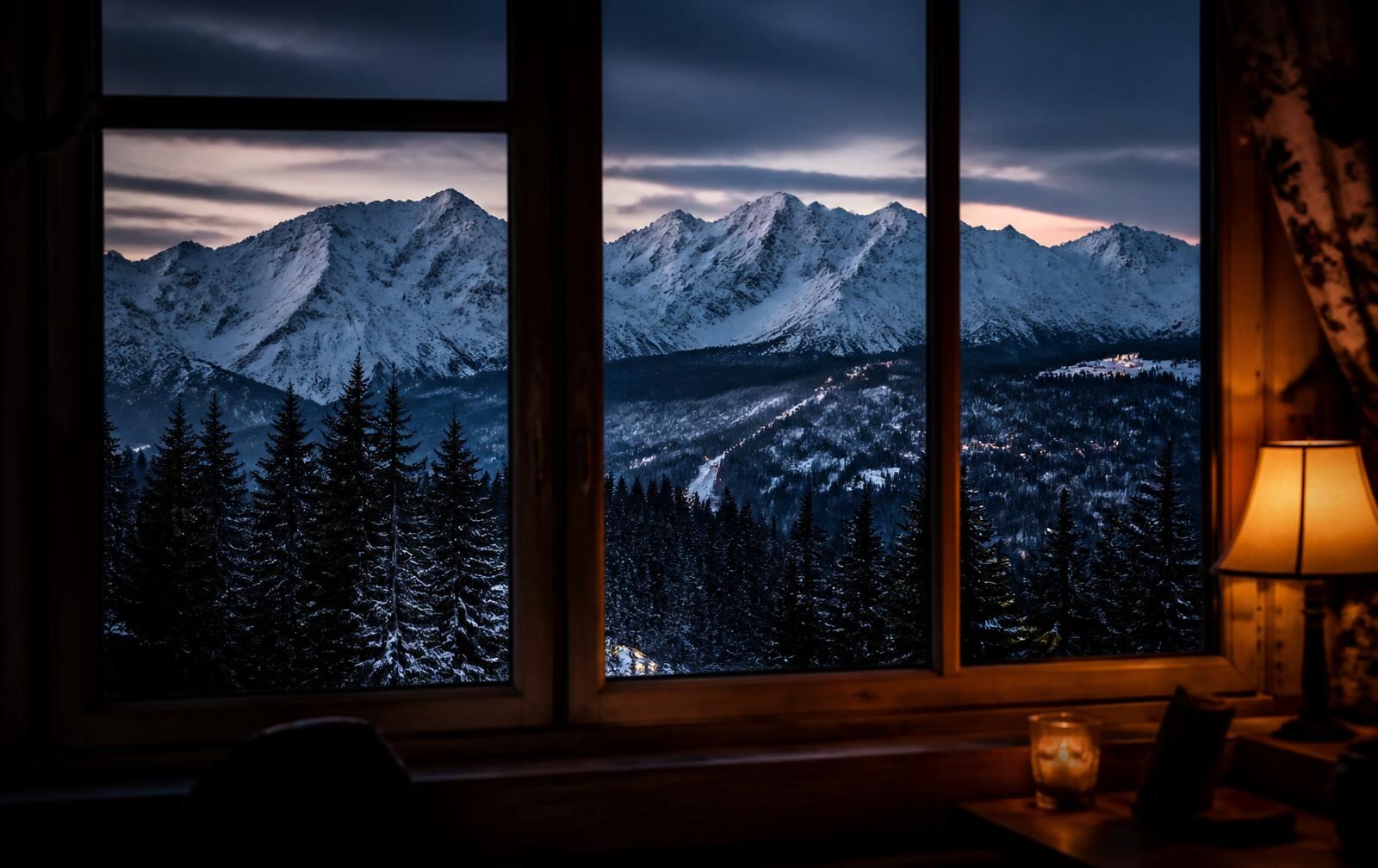 Zakopane at night in winter, timber mountain lodges under snow with warm lit windows, the dark Tatra ridgeline rising behind
